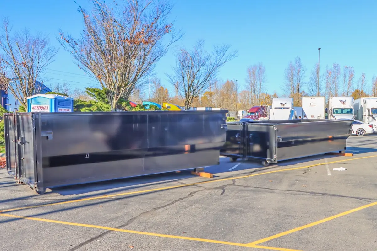 Professional dumpster rental service with roll-off container on residential driveway in Socastee